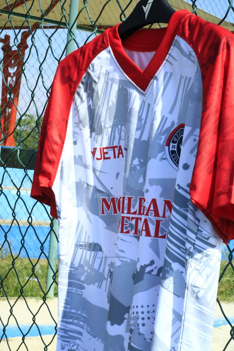 A white and red soccer jersey with abstract design